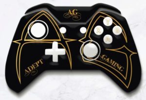 A black and gold controller with the words " adopt gaming."