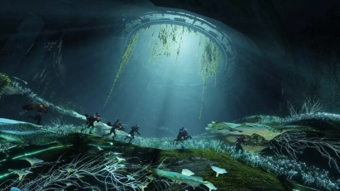 A group of people in the water under an underwater structure.