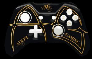 A black and gold controller with white buttons.